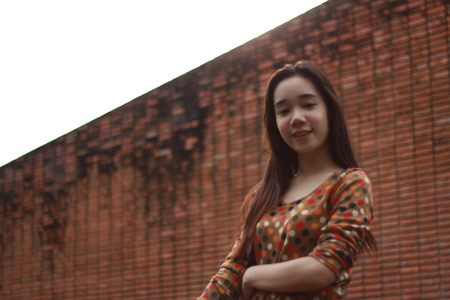 Portrait of thai student teen beautiful girl relax and smile in park.の写真素材