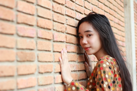 Portrait of thai student teen beautiful girl relax and smile in park.の写真素材