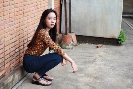 Portrait of thai student teen beautiful girl relax and smile in park.の写真素材