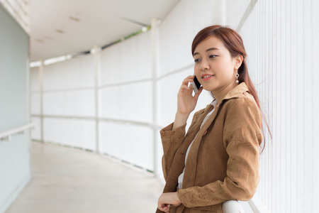 Portrait of thai adult businesswoman beautiful girl calling smart phone.の写真素材