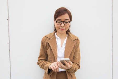 Portrait of thai adult businesswoman beautiful girl using her smart phone.の写真素材