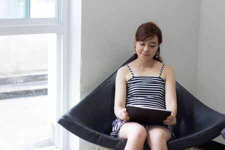 Portrait of thai adult businesswoman beautiful girl using her tablet.