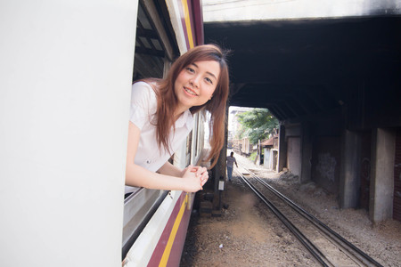 Portrait of thai student university beautiful girl relax and smile, Leisure travel by railの写真素材