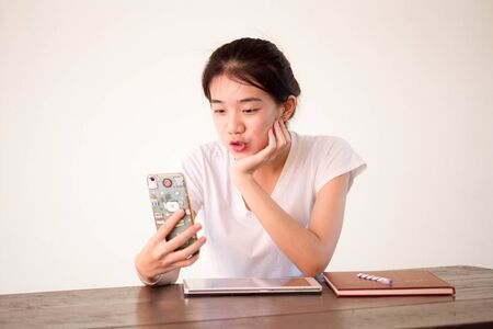 asia beautiful girl using her smart phone to Selfie.