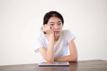 asia beautiful girl bored using her tablet