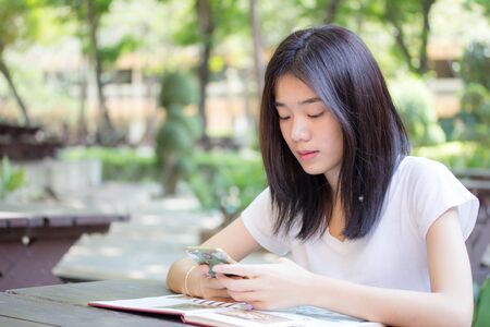 asia beautiful girl using her smart phone.の写真素材