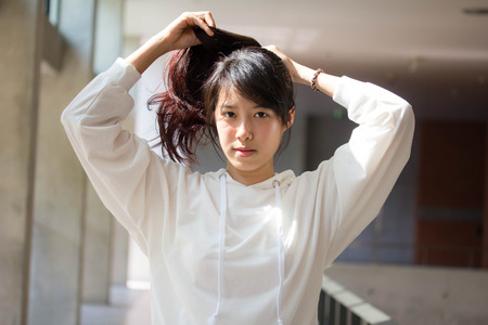 asia thai teenager Women White T-Shirt relax and smileの写真素材