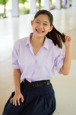 Portrait of thai student High School beautiful girl relax and smileの写真素材