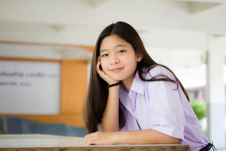 Portrait of thai student High School beautiful girl relax and smileの写真素材