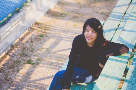 asia thai teenager Women black T-Shirt relax and smileの写真素材