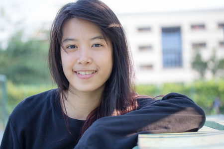 asia thai teenager Women black T-Shirt relax and smileの写真素材