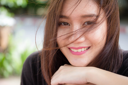Portrait of thai adult beautiful girl relax and smileの写真素材