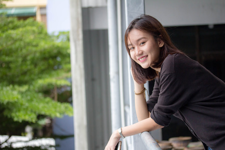 Portrait of thai adult beautiful girl relax and smileの写真素材