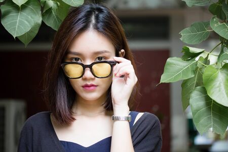 Portrait of thai adult glasses beautiful girl relax and smileの写真素材