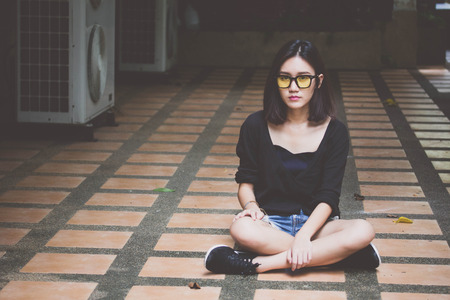 Portrait of thai adult glasses beautiful girl relax and smileの写真素材