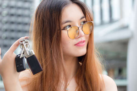 Portrait of thai chinese adult beautiful girl Denim blue bag and key