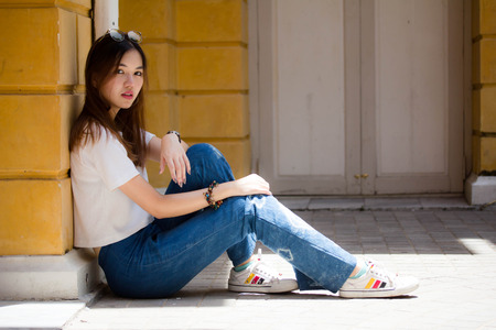 Portrait of thai chinese adult beautiful girl Denim blue bag travel relax and smileの写真素材