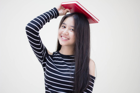 Portrait of thai teen beautiful girl reading bookのeditorial素材