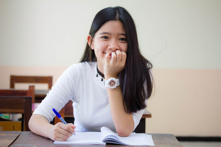 Portrait of thai teen beautiful girl reading bookの写真素材