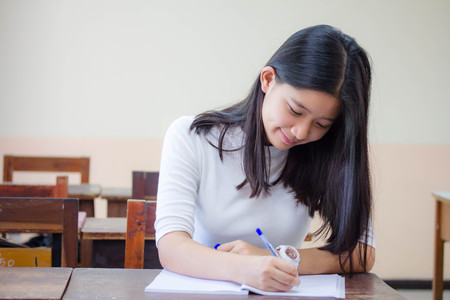 Portrait of thai teen beautiful girl reading bookの写真素材
