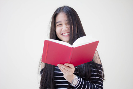 Portrait of thai teen beautiful girl reading bookの写真素材