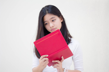 Portrait of thai teen beautiful girl reading bookの写真素材