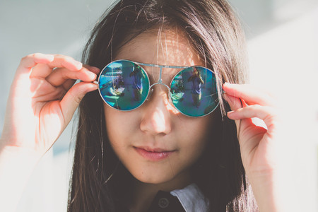 Portrait of thai teen glasses beautiful girl relax and smileの写真素材