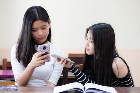 two asia thai teen Best friends beautiful girl reading bookの写真素材