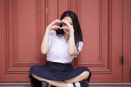 Portrait of thai high school student uniform teen beautiful girl happy and relax