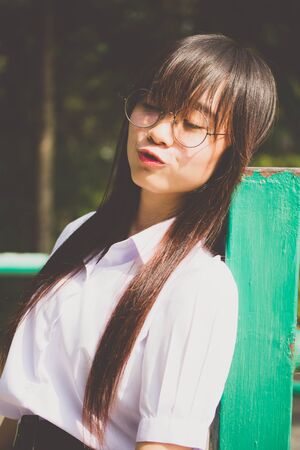 Portrait of thai high school student uniform teen glasses beautiful girl happy and relaxの写真素材