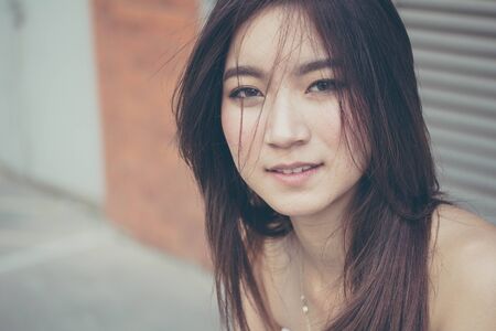 Portrait of thai china adult beautiful girl relax and smileの写真素材
