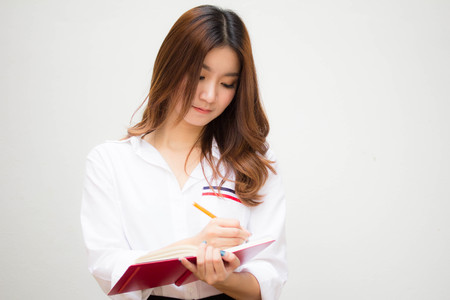 Portrait of thai adult working women white shirt Write bookの写真素材