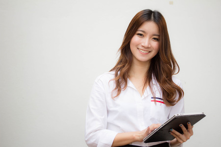 Portrait of thai adult working women white shirt using her tablet.の写真素材