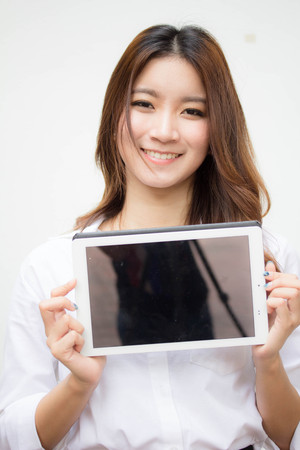 Portrait of thai adult working women white shirt using her tablet.の写真素材