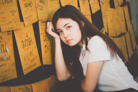 Portrait of thai adult student university uniform beautiful girl relax and smileの写真素材