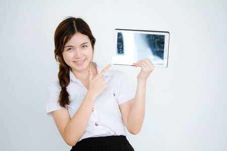 Portrait of thai adult student university uniform beautiful girl show her tablet.の写真素材
