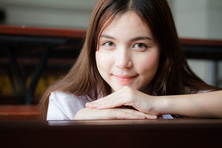 Portrait of thai adult student university uniform beautiful girl relax and smileの写真素材