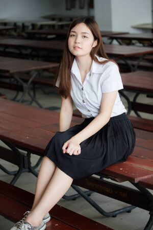 Portrait of thai adult student university uniform beautiful girl relax and smileの写真素材
