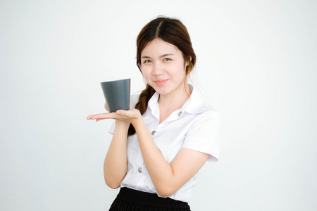 Portrait of thai adult student university uniform beautiful drinking coffeeの写真素材