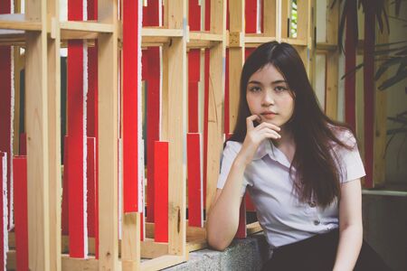 Portrait of thai adult student university uniform beautiful girl relax and smileの写真素材