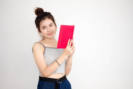 Portrait of thai adult beautiful girl read red bookの写真素材