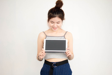 Portrait of thai adult beautiful girl show her tablet.の写真素材