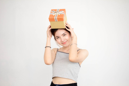 Portrait of thai adult beautiful girl hold gift box in handsの写真素材