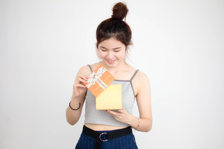 Portrait of thai adult beautiful girl hold gift box in handsの写真素材