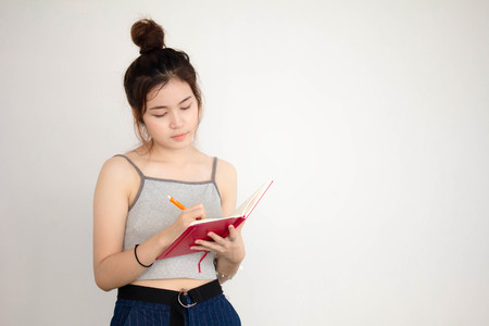 Portrait of thai adult beautiful girl Write bookの写真素材