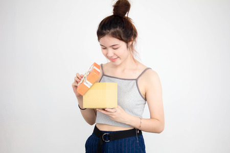 Portrait of thai adult beautiful girl hold gift box in handsの写真素材