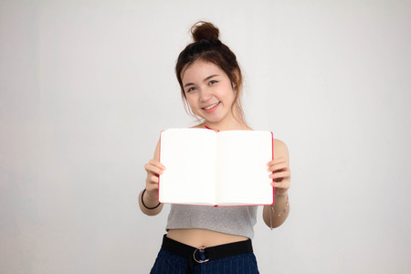 Portrait of thai adult beautiful girl read red bookの写真素材