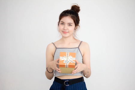 Portrait of thai adult beautiful girl hold gift box in handsの写真素材