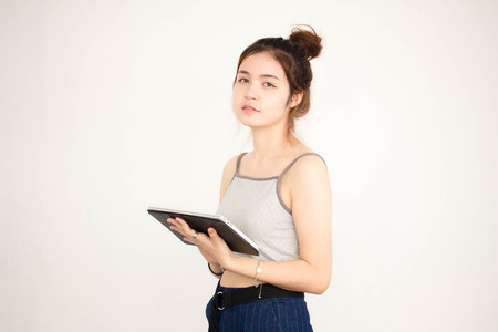 Portrait of thai adult beautiful girl using her tablet.の写真素材