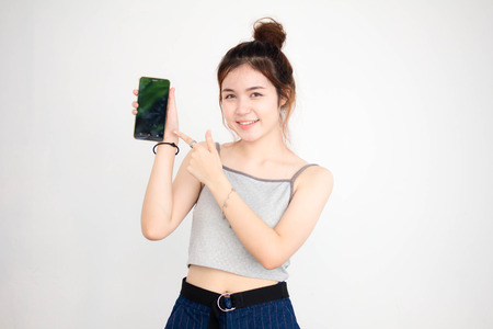 Portrait of thai adult beautiful girl show her smart phoneの写真素材